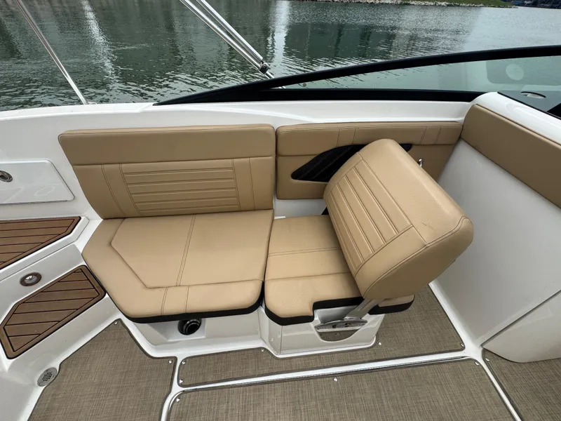 Slide: The Image of 2019 Sea Ray SPX 230 boat interior with tan seating and sleek design. - 14