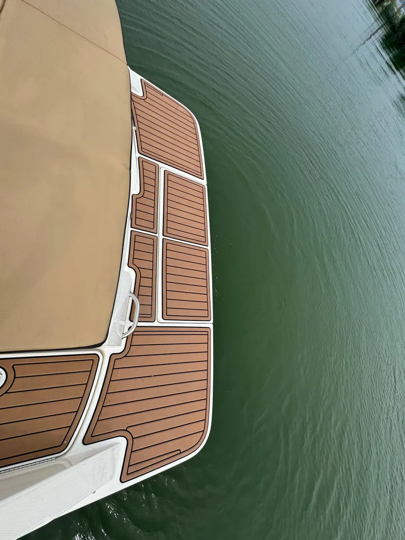 Slide: The Image of 2019 Sea Ray SPX 230 boat deck on calm water. - 17