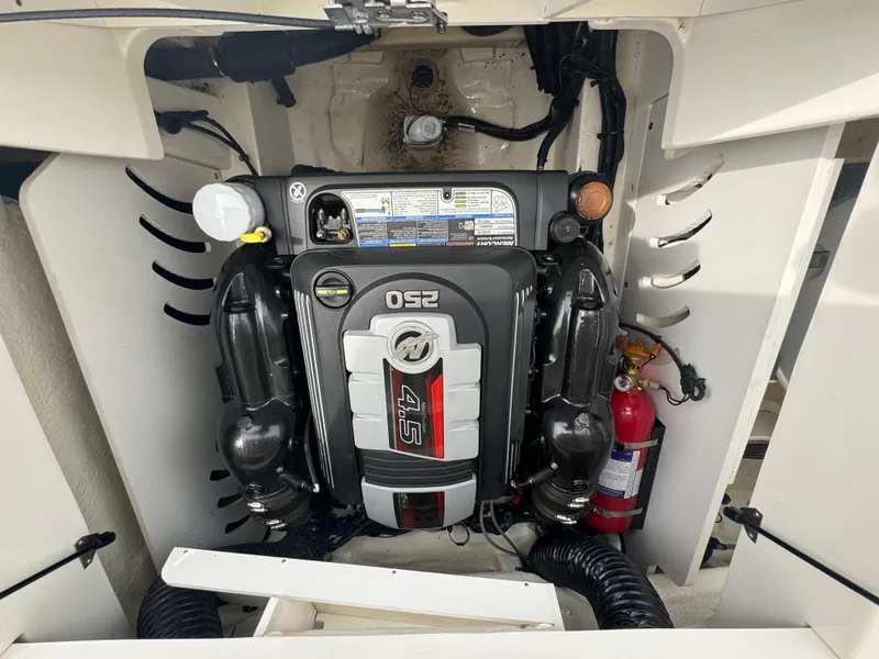 Slide: The Image of 2019 Sea Ray SPX 230 engine compartment with visible 4.5L engine and fire extinguisher. - 19