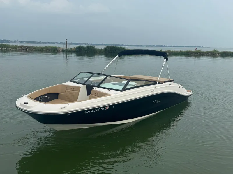 Slide: The Image of 2019 Sea Ray SPX 230 boat on calm water with scenic background. - 2