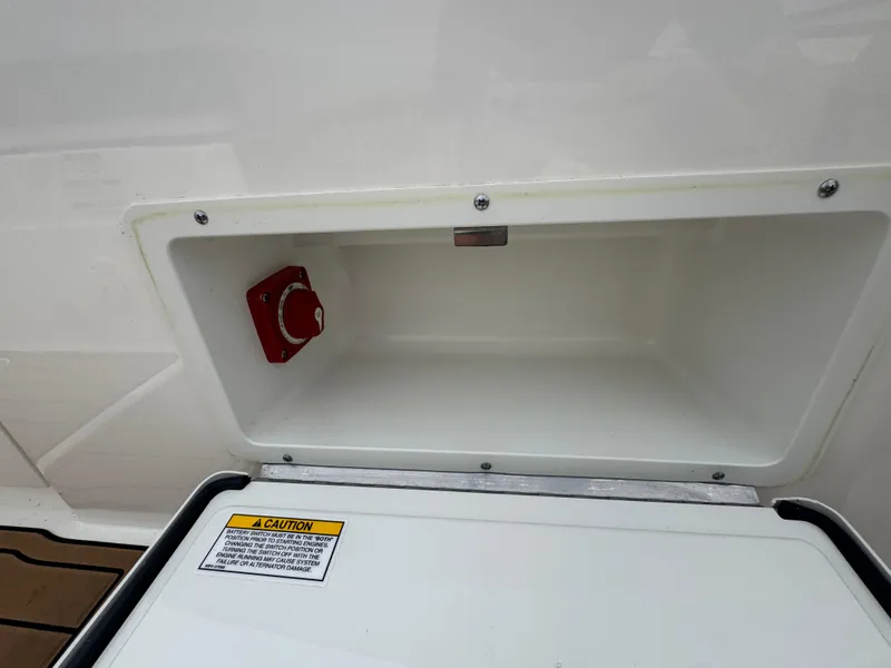 Slide: The Image of Compartment with red switch on 2019 Sea Ray SPX 230 boat. - 21