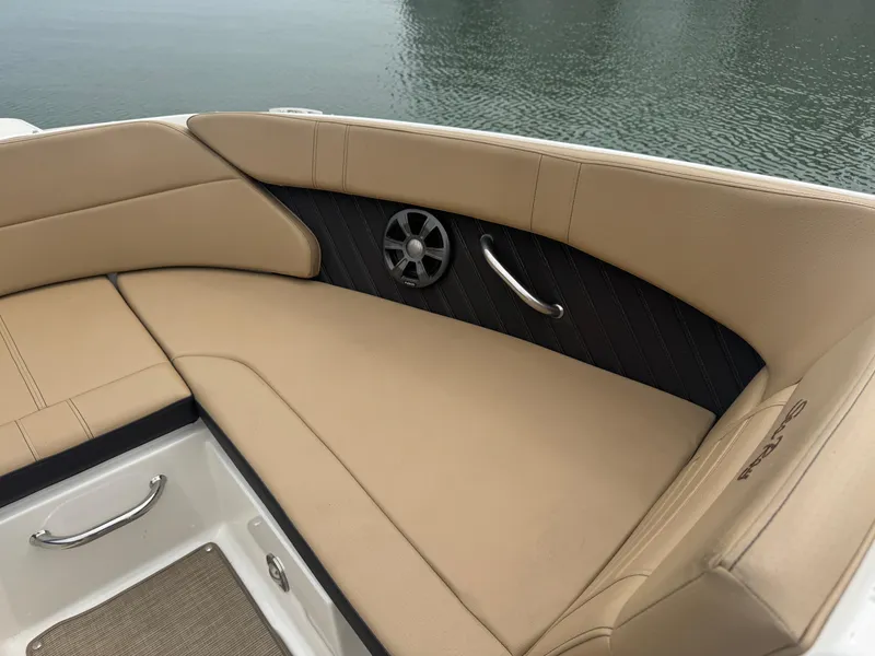 Slide: The Image of 2019 Sea Ray SPX 230 boat interior with beige seating and speaker detail. - 7