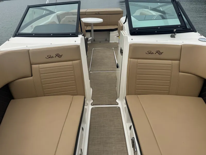 Slide: The Image of 2019 Sea Ray SPX 230 boat interior with tan seating and open deck layout. - 8
