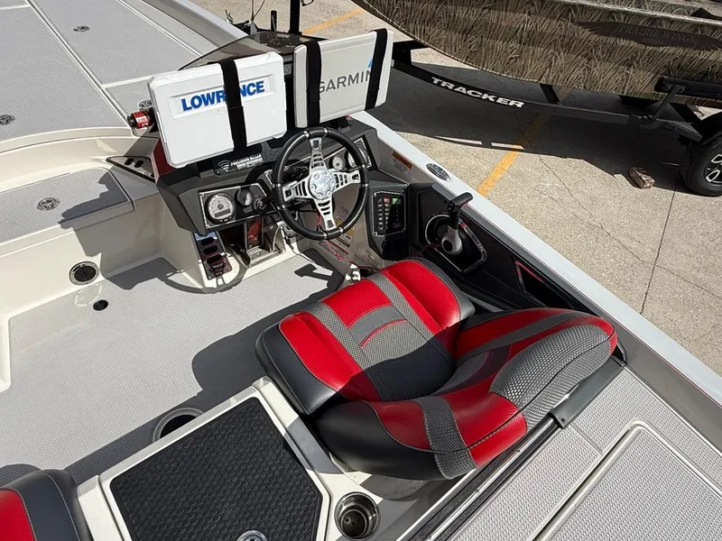 Slide: The Image of 2021 Ranger Z521L Intracoastal boat cockpit with red and gray seating, advanced navigation systems. - 13