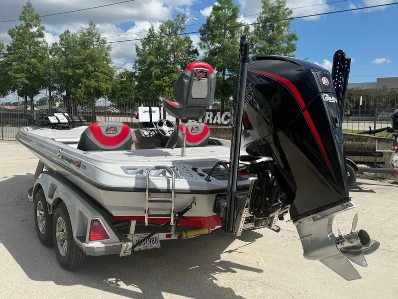 Slide: The Image of 2021 Ranger Z521L Intracoastal boat with powerful outboard motor, parked outdoors. - 4