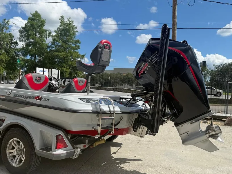 Slide: The Image of 2021 Ranger Z521L Intracoastal boat on trailer, featuring powerful outboard motor. - 5
