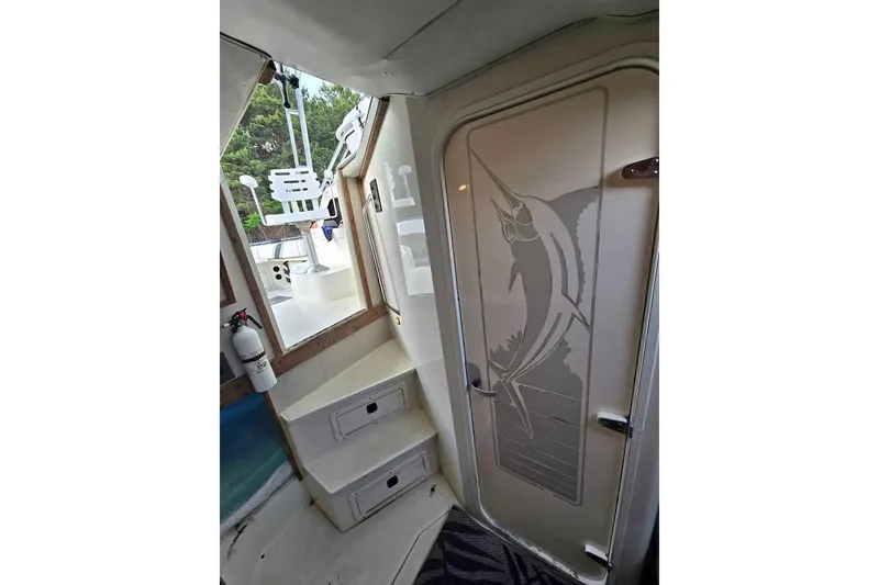 Slide: The Image of Interior of 1998 Hydra-Sports 3100 SF boat with marlin design on door. - 6