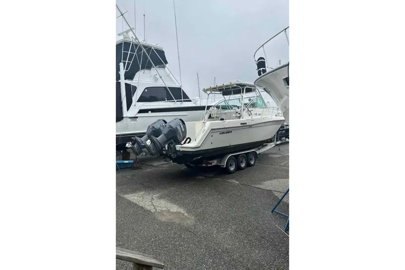 Slide: The Image of 1998 Hydra-Sports 3100 SF boat on trailer, parked in marina. - 7