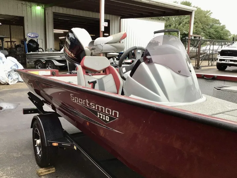 Slide: The Image of 2020 G3 1710 Sportsman boat in a showroom, featuring sleek design and modern equipment. - 12