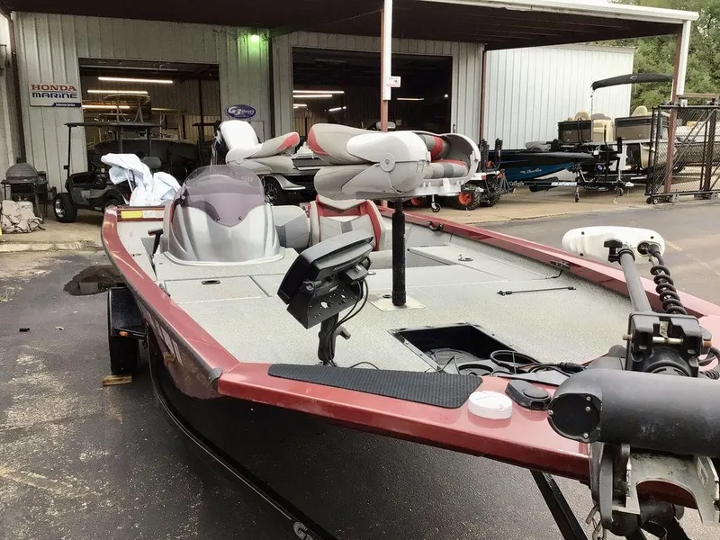Slide: The Image of 2020 G3 1710 SPORTSMAN boat with fishing equipment, parked outside a marine shop. - 14