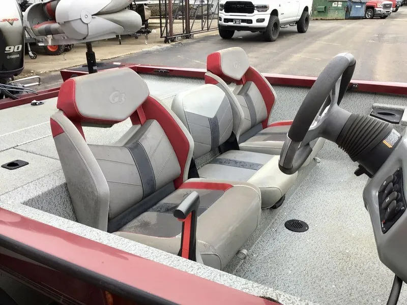Slide: The Image of 2020 G3 1710 SPORTSMAN boat interior with red and gray seating and steering console. - 18