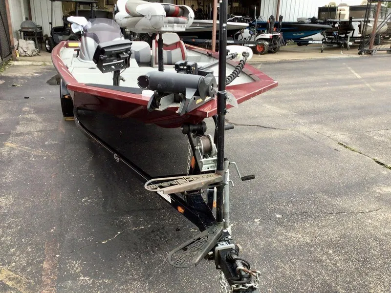 Slide: The Image of 2020 G3 1710 SPORTSMAN boat on trailer, parked outdoors, featuring red and gray design. - 23