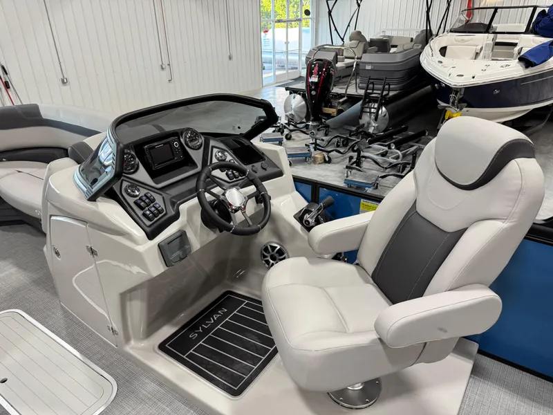 Slide: The Image of 2025 Sylvan L5 CLZ DH boat interior with modern helm and comfortable captain's chair. - 13