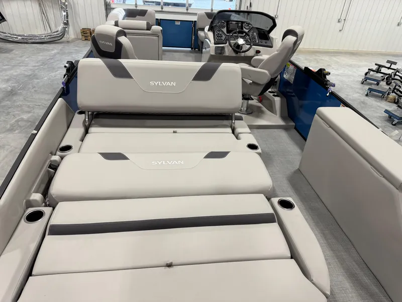 Slide: The Image of 2025 Sylvan L5 CLZ DH boat interior with plush seating and modern dashboard. - 18