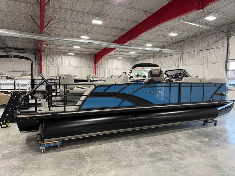 Slide: The Image of 2025 Sylvan L5 CLZ DH pontoon boat in a spacious indoor showroom. - 3