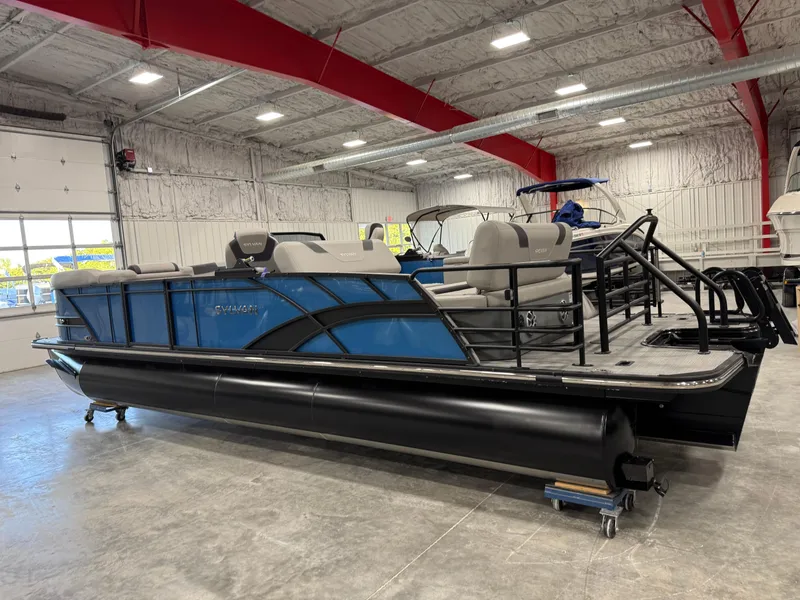 Slide: The Image of 2025 Sylvan L5 CLZ DH pontoon boat in a showroom, featuring sleek design and modern seating. - 4