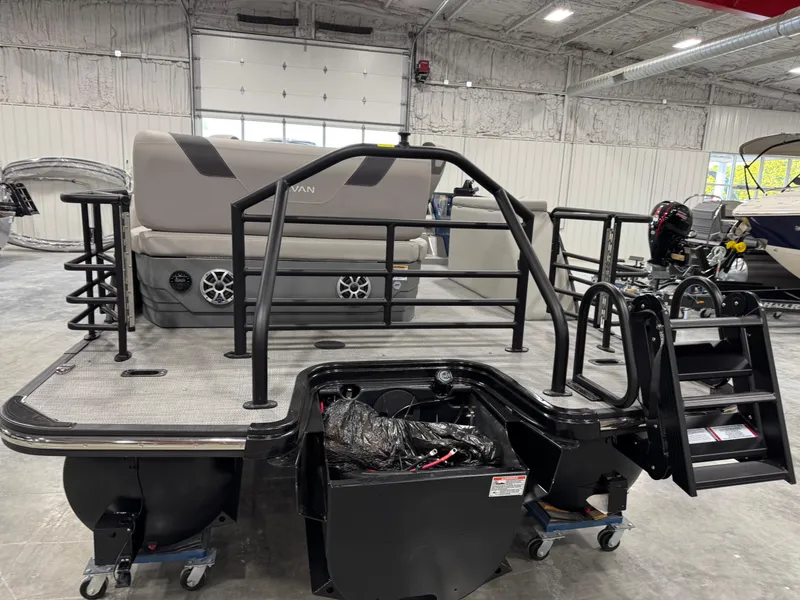 Slide: The Image of 2025 Sylvan L5 CLZ DH pontoon boat in showroom, featuring spacious deck and modern design. - 5