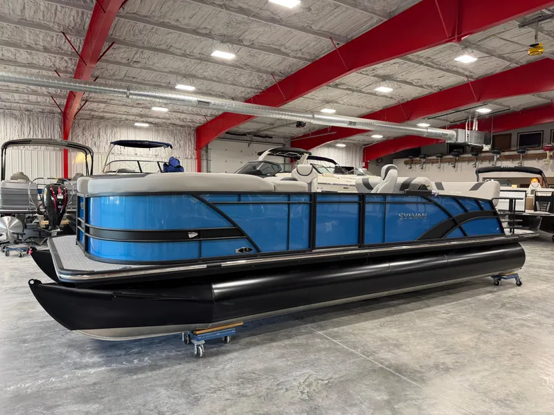 Slide: The Image of 2025 Sylvan L5 CLZ DH pontoon boat in a showroom with red beams. - 6