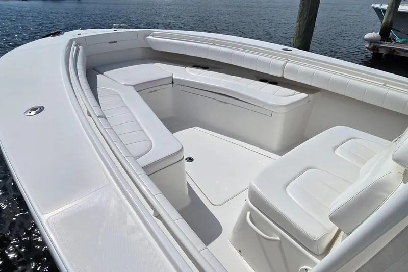 Slide: The Image of 2014 Regulator 28 Forward Seating boat with white cushioned seats and spacious deck. - 11
