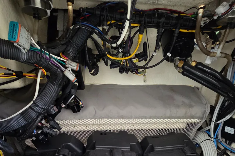 Slide: The Image of 2014 Regulator 28 Forward Seating boat wiring and components in the engine compartment. - 13