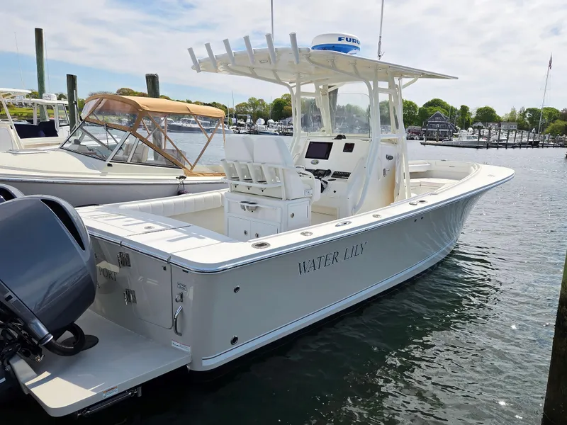 Slide: The Image of 2014 Regulator 28 Forward Seating boat docked in a marina. - 2