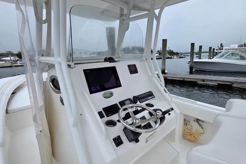 Slide: The Image of 2014 Regulator 28 Forward Seating boat console with steering wheel and navigation controls. - 5