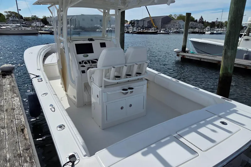 Slide: The Image of 2014 Regulator 28 Forward Seating boat docked at a marina. - 6