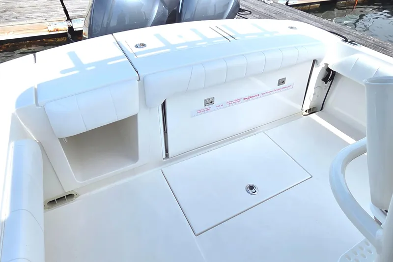 Slide: The Image of 2014 Regulator 28 Forward Seating boat interior with storage compartments and seating. - 8