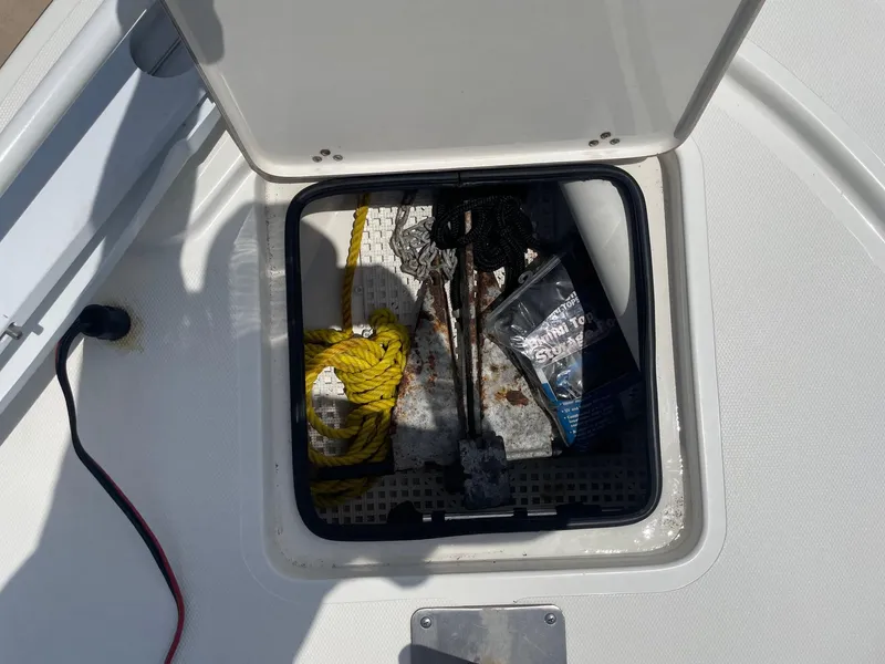 Slide: The Image of Open storage compartment on 2013 Mako 18lts boat with anchor and rope. - 15