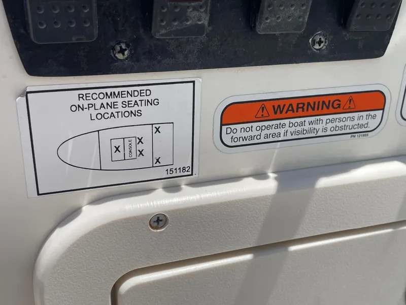 Slide: The Image of Safety warnings and seating diagram on a 2013 Mako 18lts boat. - 23