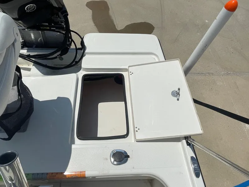 Slide: The Image of Open storage compartment on 2013 Mako 18lts boat deck. - 27