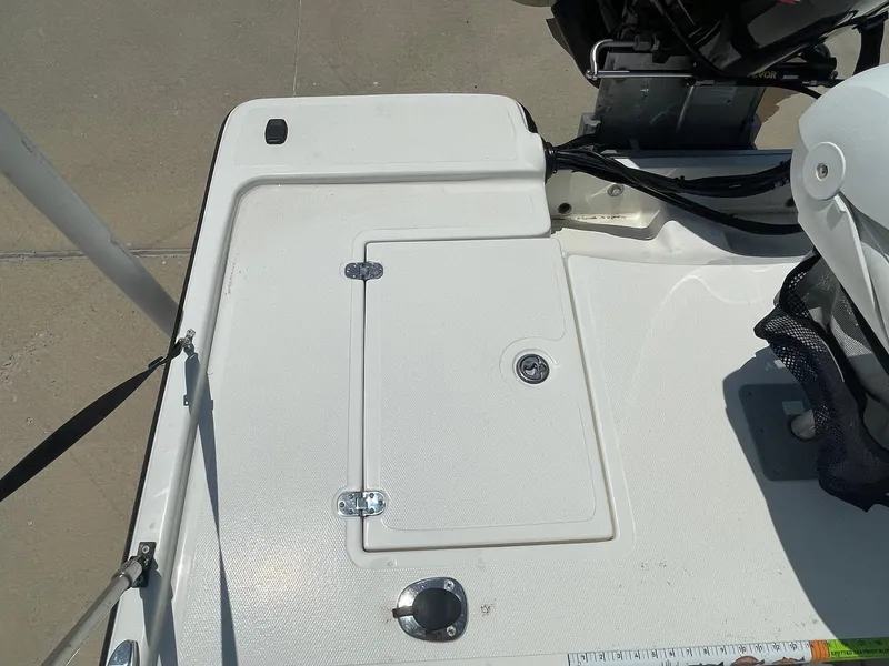 Slide: The Image of 2013 Mako 18lts boat deck with storage compartment and motor. - 28