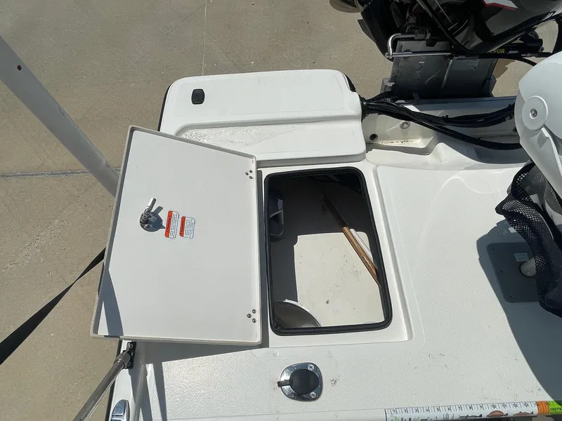 Slide: The Image of Open storage compartment on a 2013 Mako 18lts boat deck. - 29