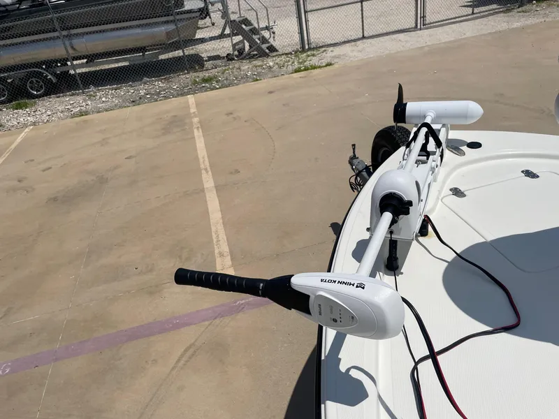 Slide: The Image of Trolling motor on 2013 Mako 18lts boat, parked near a fence. - 31