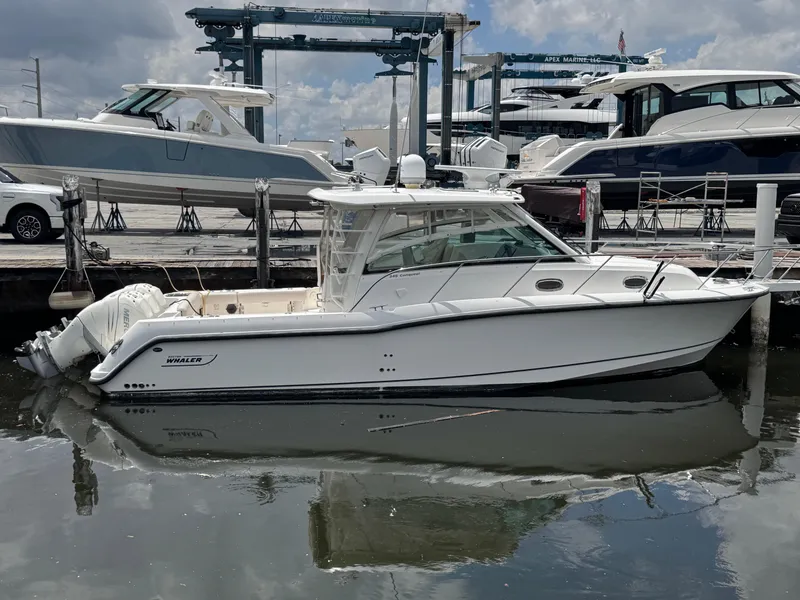 The Image of 2015 Boston Whaler 345 Conquest boat docked at marina, side view. - 0