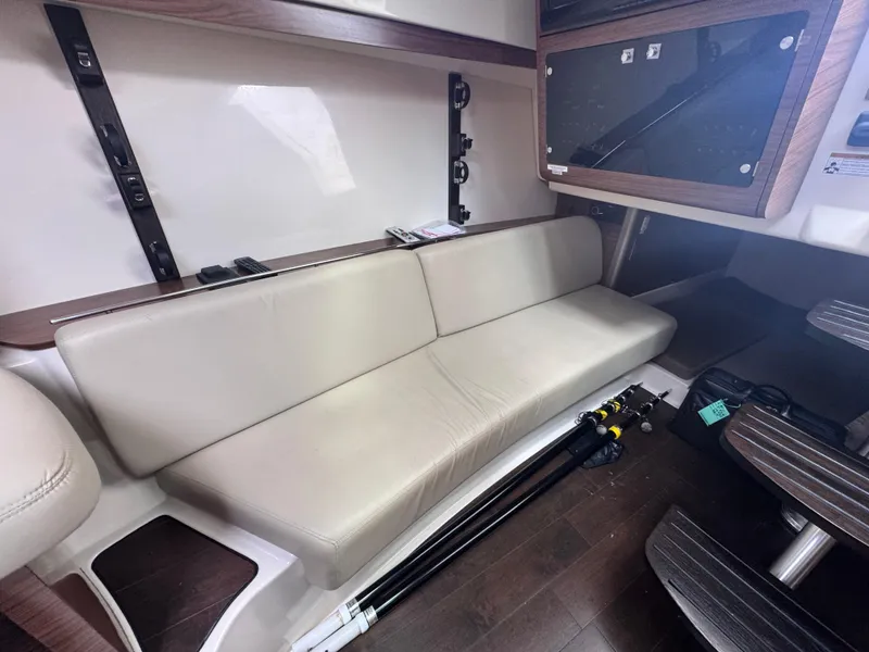 Slide: The Image of 2015 Boston Whaler 345 Conquest interior with beige seating and wood accents. - 12