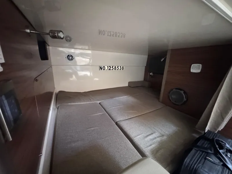 Slide: The Image of Interior cabin of 2015 Boston Whaler 345 Conquest, featuring cozy sleeping area. - 14