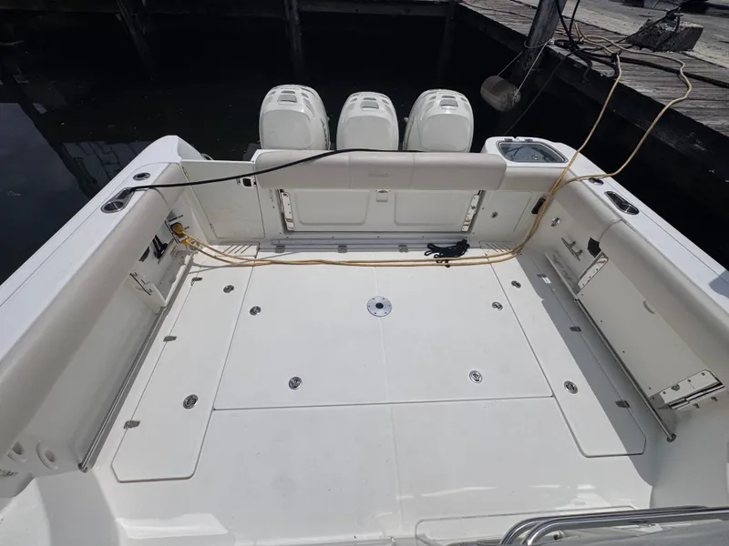 Slide: The Image of 2015 Boston Whaler 345 Conquest boat deck with triple outboard engines. - 16