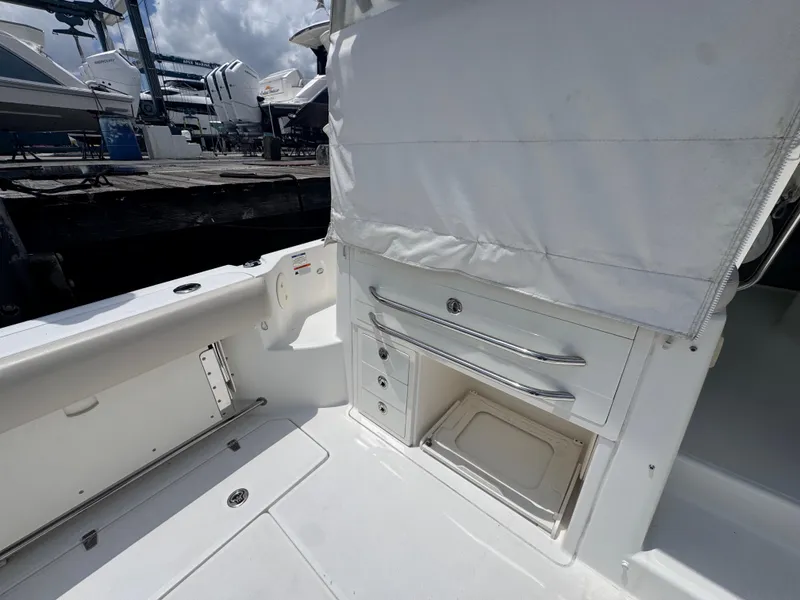 Slide: The Image of 2015 Boston Whaler 345 Conquest interior with storage compartments and seating area. - 17