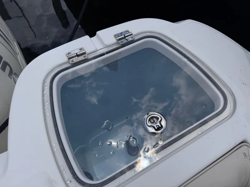 Slide: The Image of Livewell on a 2015 Boston Whaler 345 Conquest boat, featuring a clear lid and water droplets. - 20