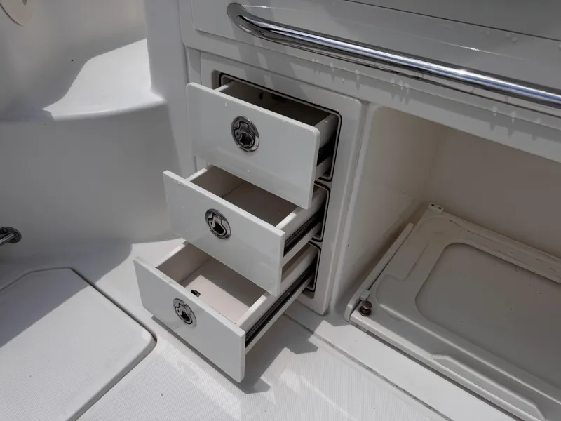 Slide: The Image of Open storage drawers on a 2015 Boston Whaler 345 Conquest boat. - 23