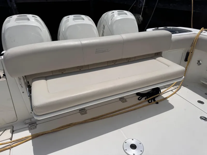 Slide: The Image of 2015 Boston Whaler 345 Conquest boat with foldable bench seat and triple outboard engines. - 24