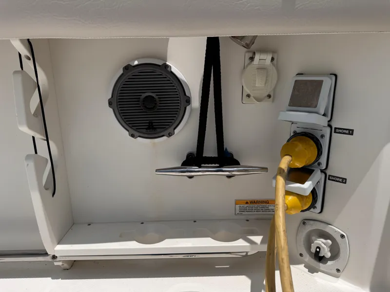 Slide: The Image of 2015 Boston Whaler 345 Conquest boat electrical panel with speaker and power cords. - 25