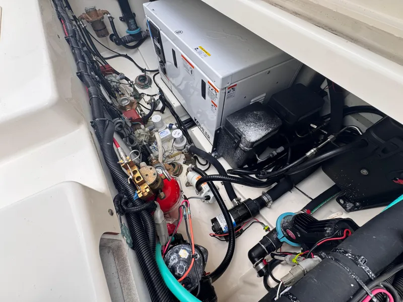 Slide: The Image of Engine compartment of a 2015 Boston Whaler 345 Conquest, showcasing wiring and components. - 27