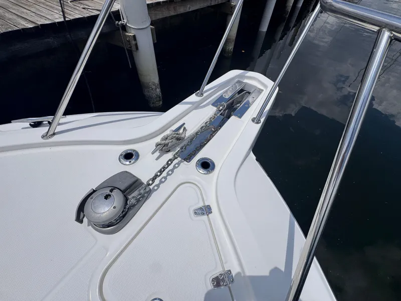 Slide: The Image of Bow of 2015 Boston Whaler 345 Conquest with anchor and railing, docked at marina. - 30