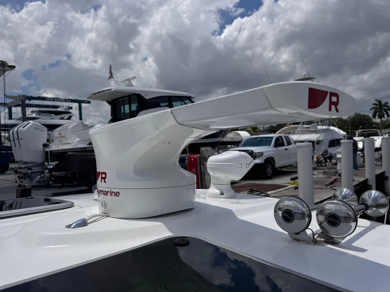 Slide: The Image of 2015 Boston Whaler 345 Conquest radar system at marina, cloudy sky background. - 34