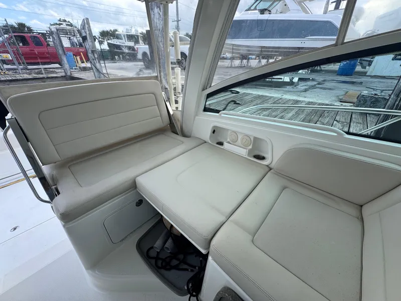 Slide: The Image of 2015 Boston Whaler 345 Conquest interior seating area with beige upholstery. - 39