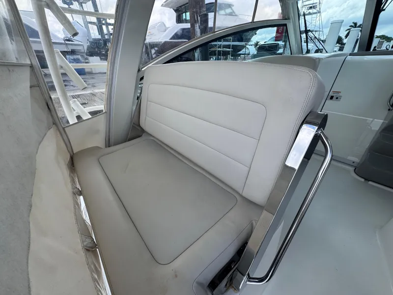 Slide: The Image of Interior seating of 2015 Boston Whaler 345 Conquest boat, featuring cushioned bench. - 45
