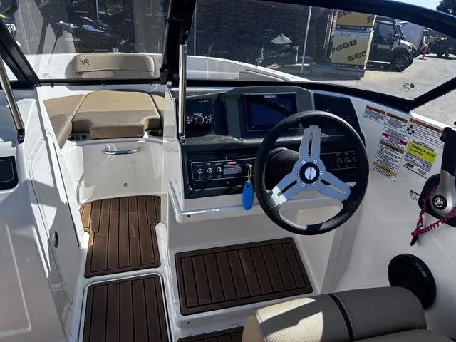 Slide: The Image of 2023 Bayliner VR4 Bowrider interior with steering wheel, dashboard, and seating. - 6