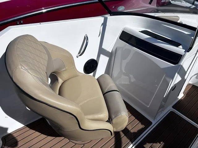 Slide: The Image of 2023 Bayliner VR4 Bowrider interior with beige captain's chair and wood-style flooring. - 7